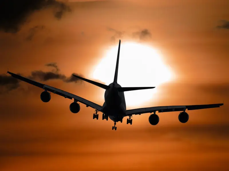 A plane taking off at sunset