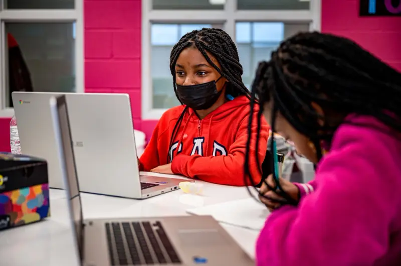 Two students working on laptops